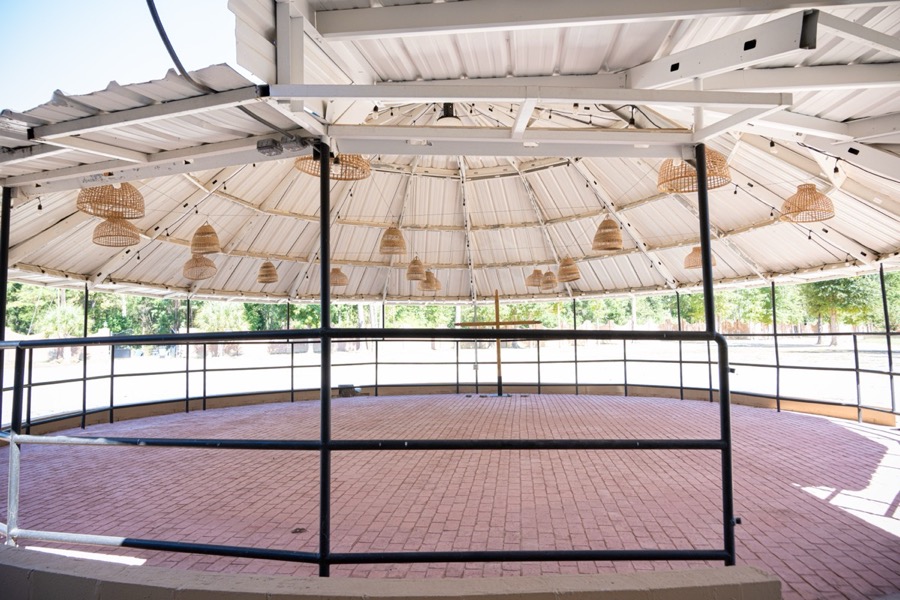Inspira Ranch round outdoor gazebo with rattan pendant lights and brick herringbone floor