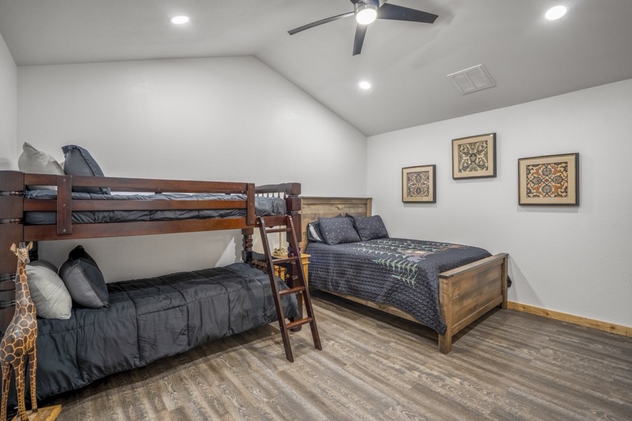 Inspira Ranch barndominium private bedroom with rustic furnishings and comfortable bedding